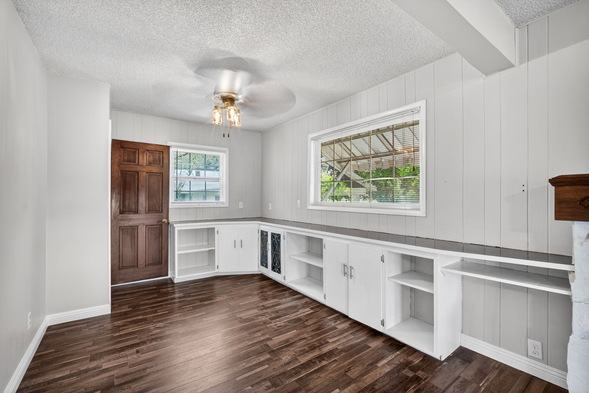 Room featuring wood-finish flooring and a ceiling fan