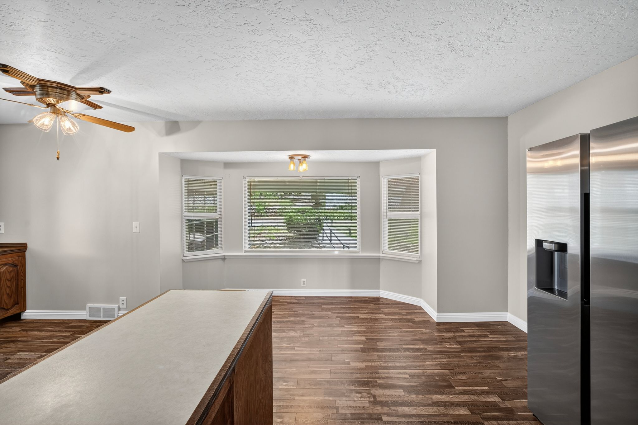 Bay window area featuring wood-finish flooring and a ceiling-mounted light fixture