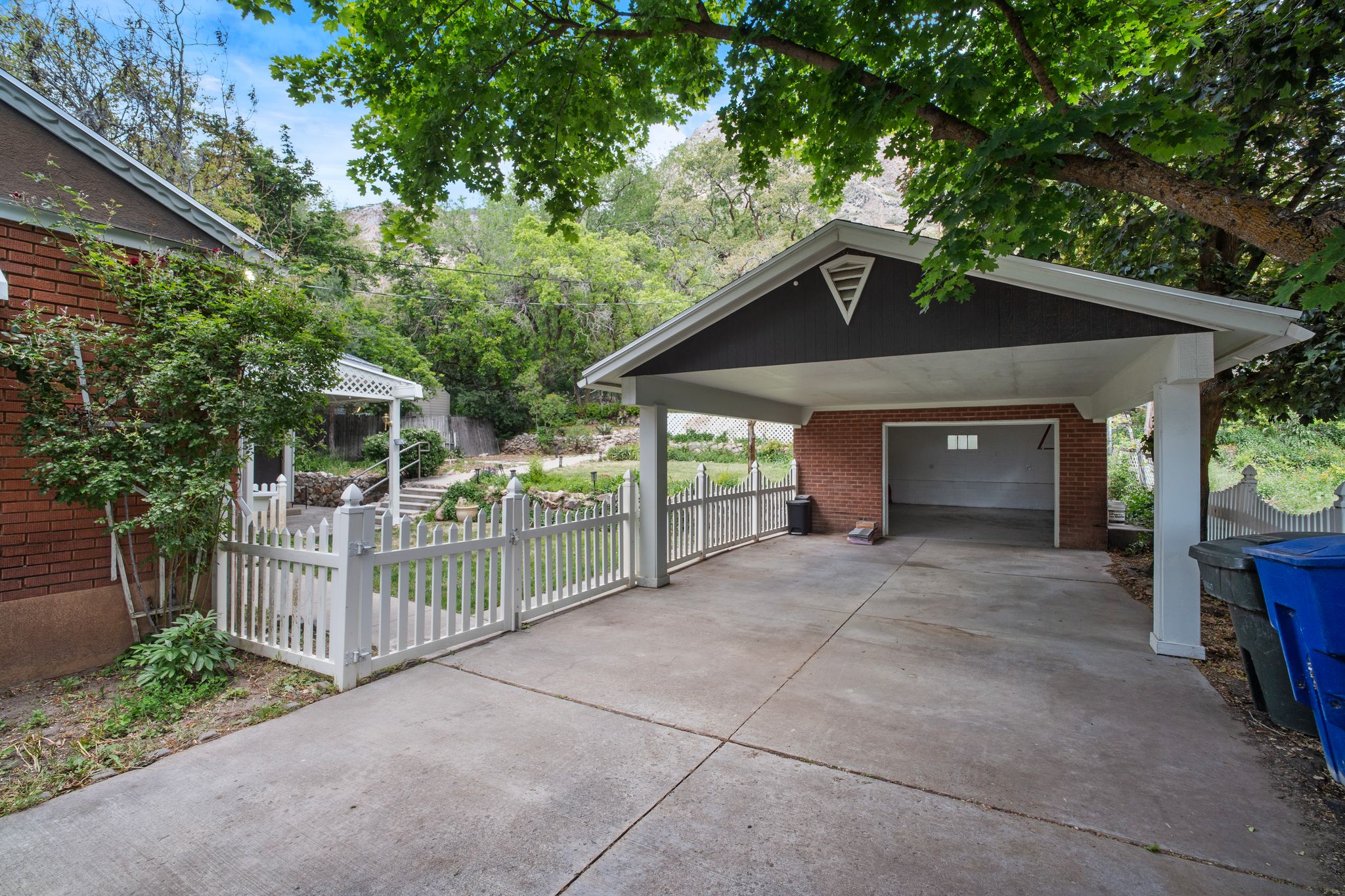 Covered carport with a brick-clad garage
