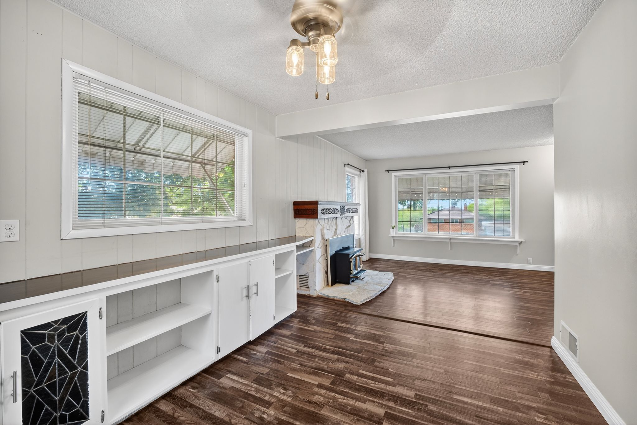 White built-in cabinetry with open shelving and decorative glass paneling