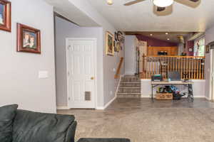 Split-level interior featuring wood-finish flooring, a neutral wall palette, and a paneled white door