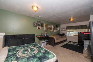 Carpeted room featuring a window with blinds, recessed lighting, and a neutral ceiling