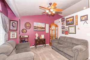 Carpeted interior space featuring a ceiling fan with integrated lighting, vaulted ceiling, and recessed lighting