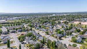 Aerial perspective showcasing a residential neighborhood with a variety of single-family homes and mature trees