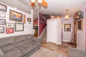 Entryway featuring wood-finish flooring, a white paneled door, and an ornate pendant light fixture