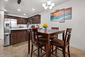 Kitchen area featuring dark wood-finish cabinetry, stainless steel appliances, and light-toned countertops
