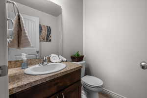 Bathroom featuring a built-in vanity with a speckled countertop, an undermount sink, and a chrome faucet
