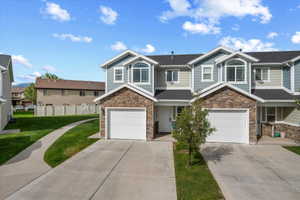 Townhome exterior featuring stone veneer and horizontal siding