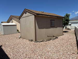 Workshop with a shingled roof and exterior window