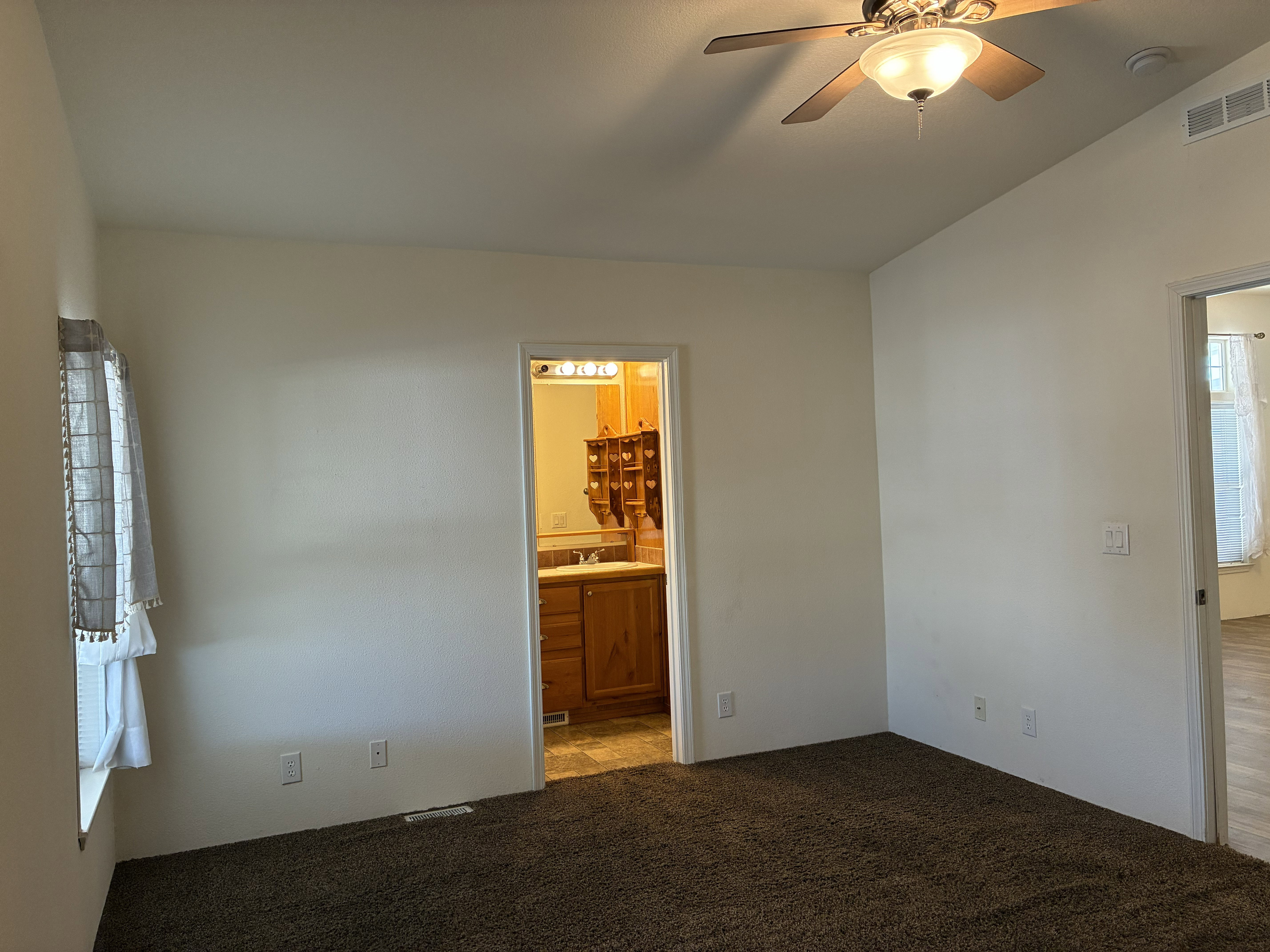 Primary bedroom with ceiling fan