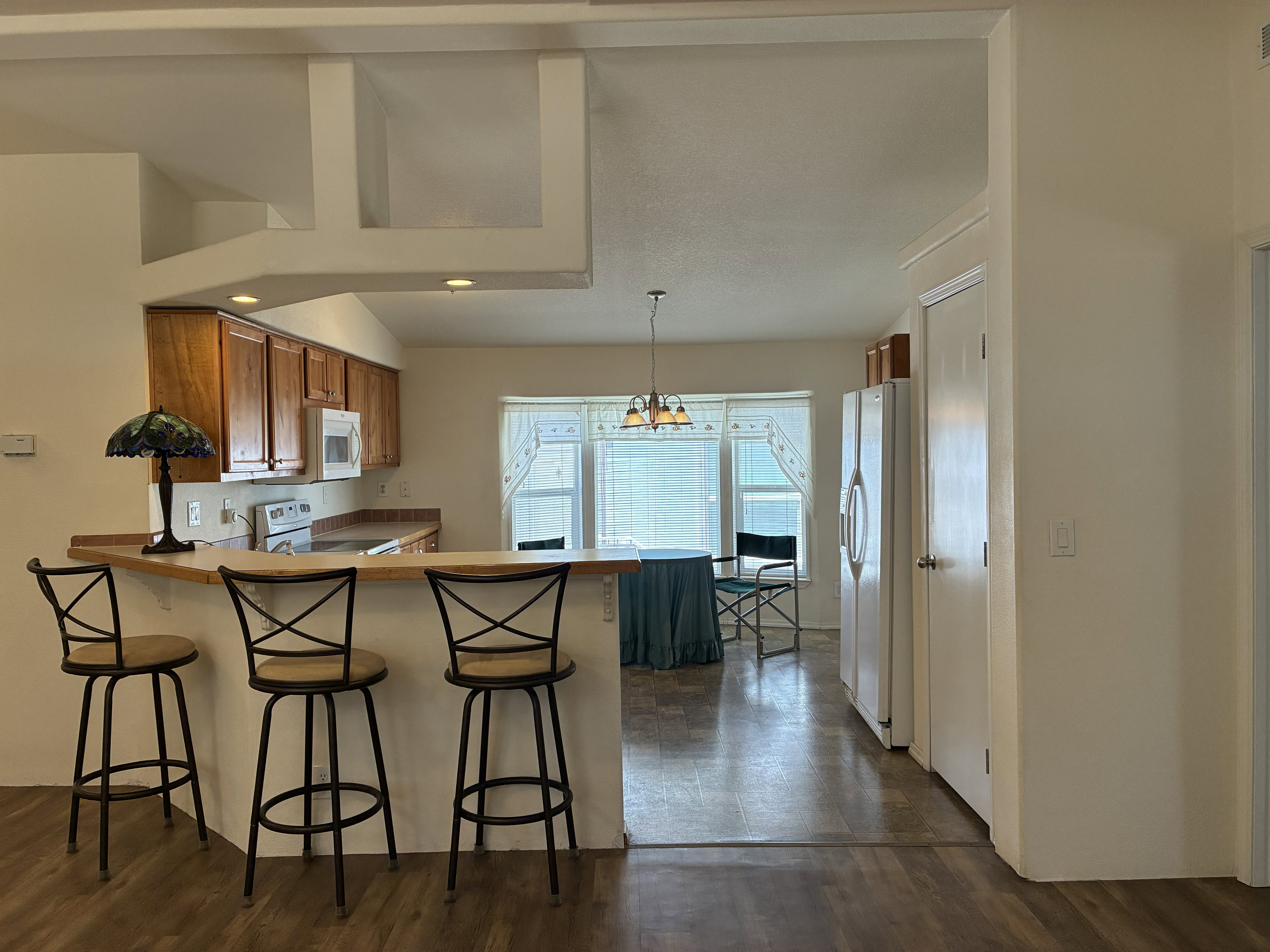 Kitchen area featuring a breakfast bar and wood cabinetry
