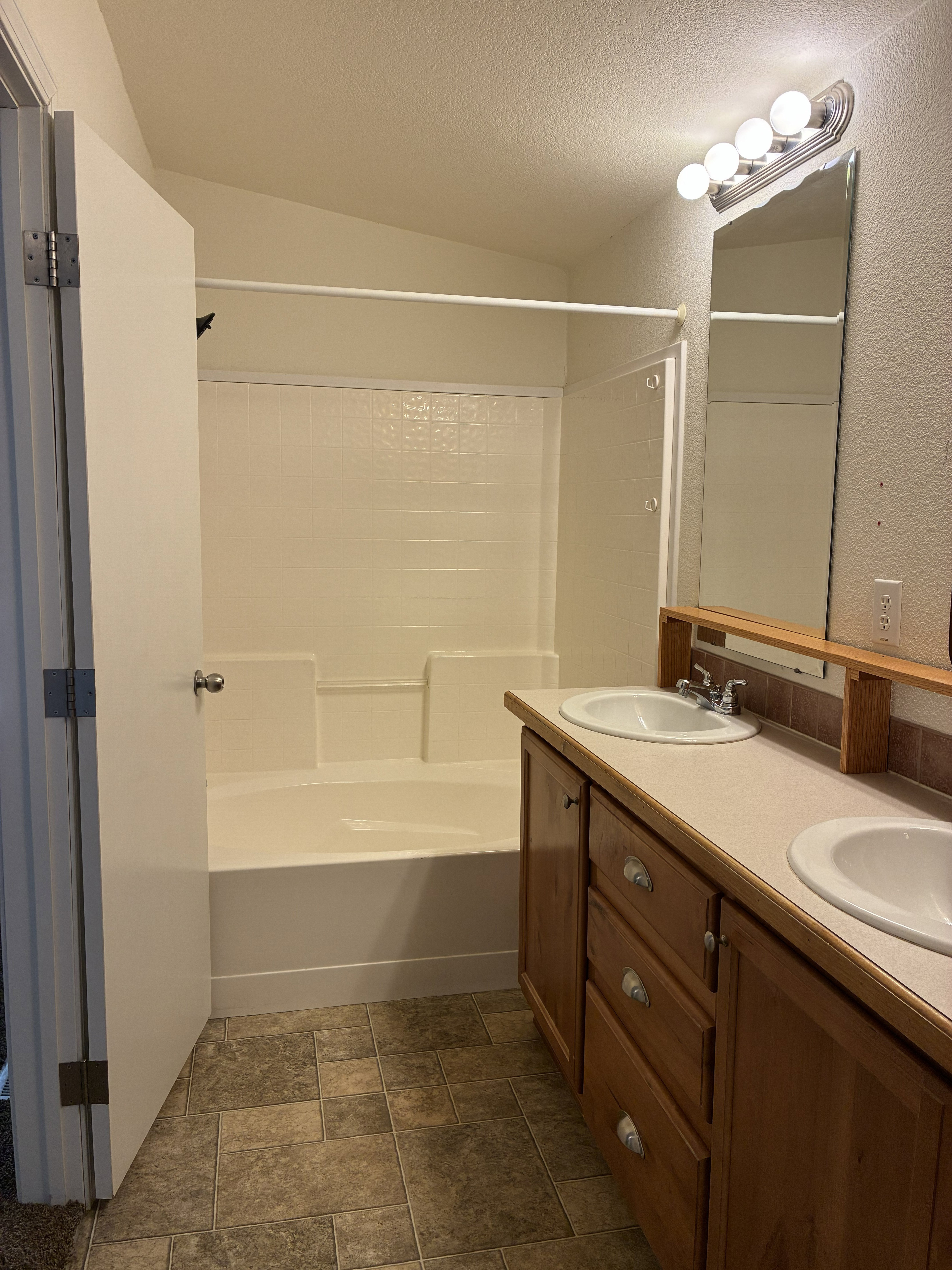 Double vanity featuring integrated sinks and wood-finish cabinetry