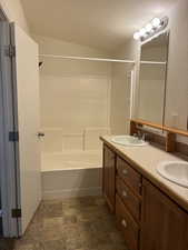 Double vanity featuring integrated sinks and wood-finish cabinetry