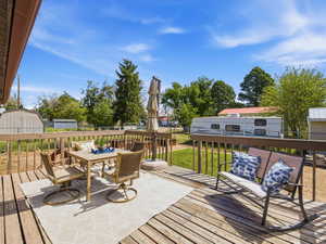 Wood deck with a baluster railing and a light-colored ground cover