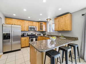 Kitchen featuring light wood cabinetry and stone countertops