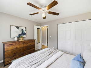 Room featuring light gray walls and a white ceiling with a decorative ceiling fan