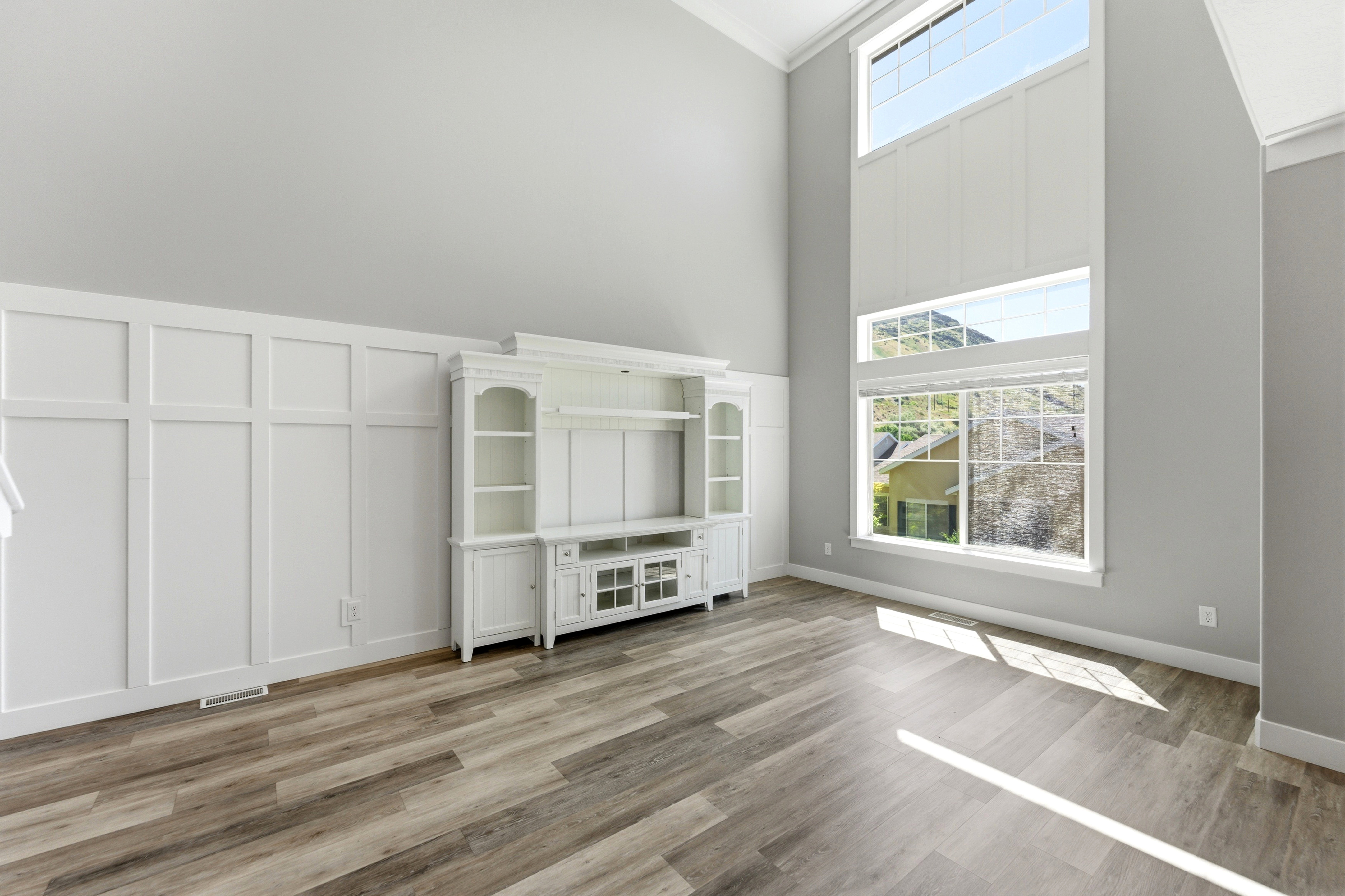 Vaulted ceilings enhance this living space featuring board and batten wall detailing