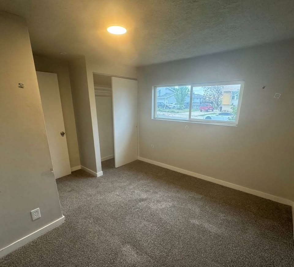 Unfurnished bedroom with carpet and a closet