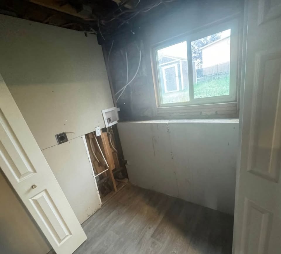 Laundry area with hookup for a washing machine and light wood finished floors