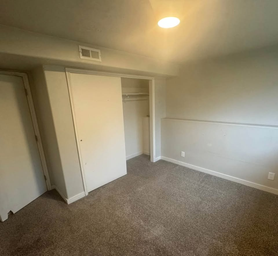 Unfurnished bedroom with carpet floors and a closet