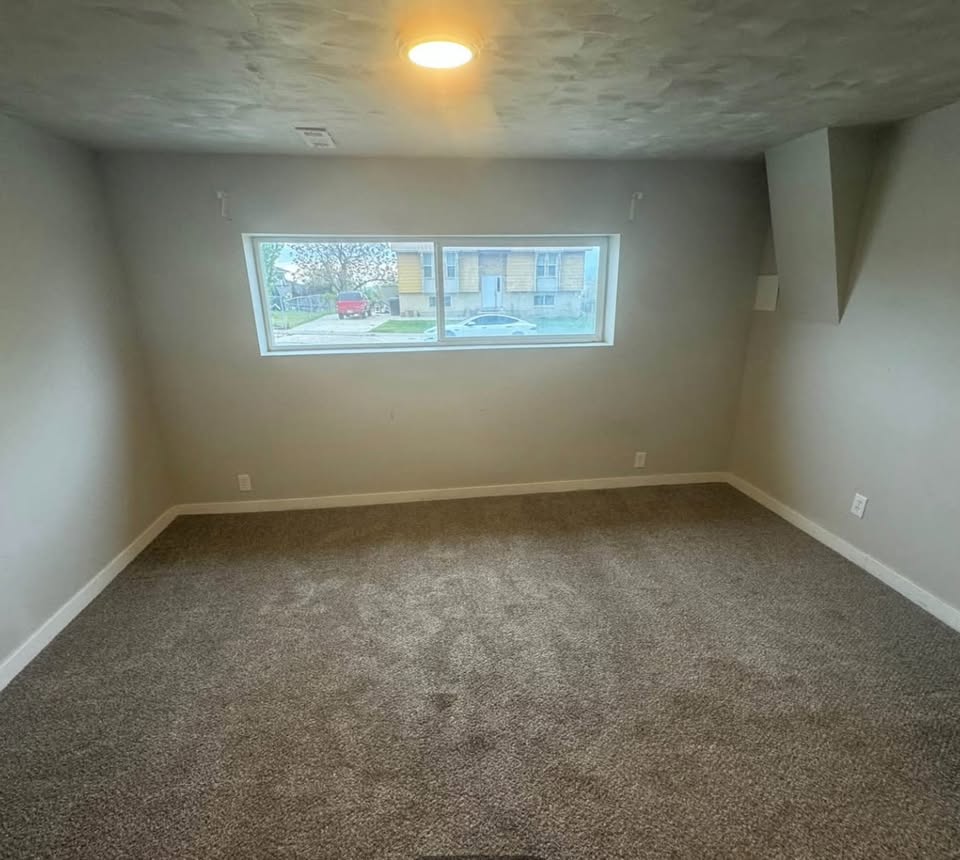 Spare room with carpet flooring and a textured ceiling