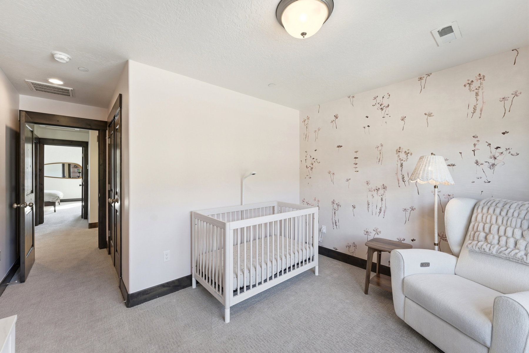 Bedroom featuring a decorative accent wall, recessed lighting, and light-toned carpeting