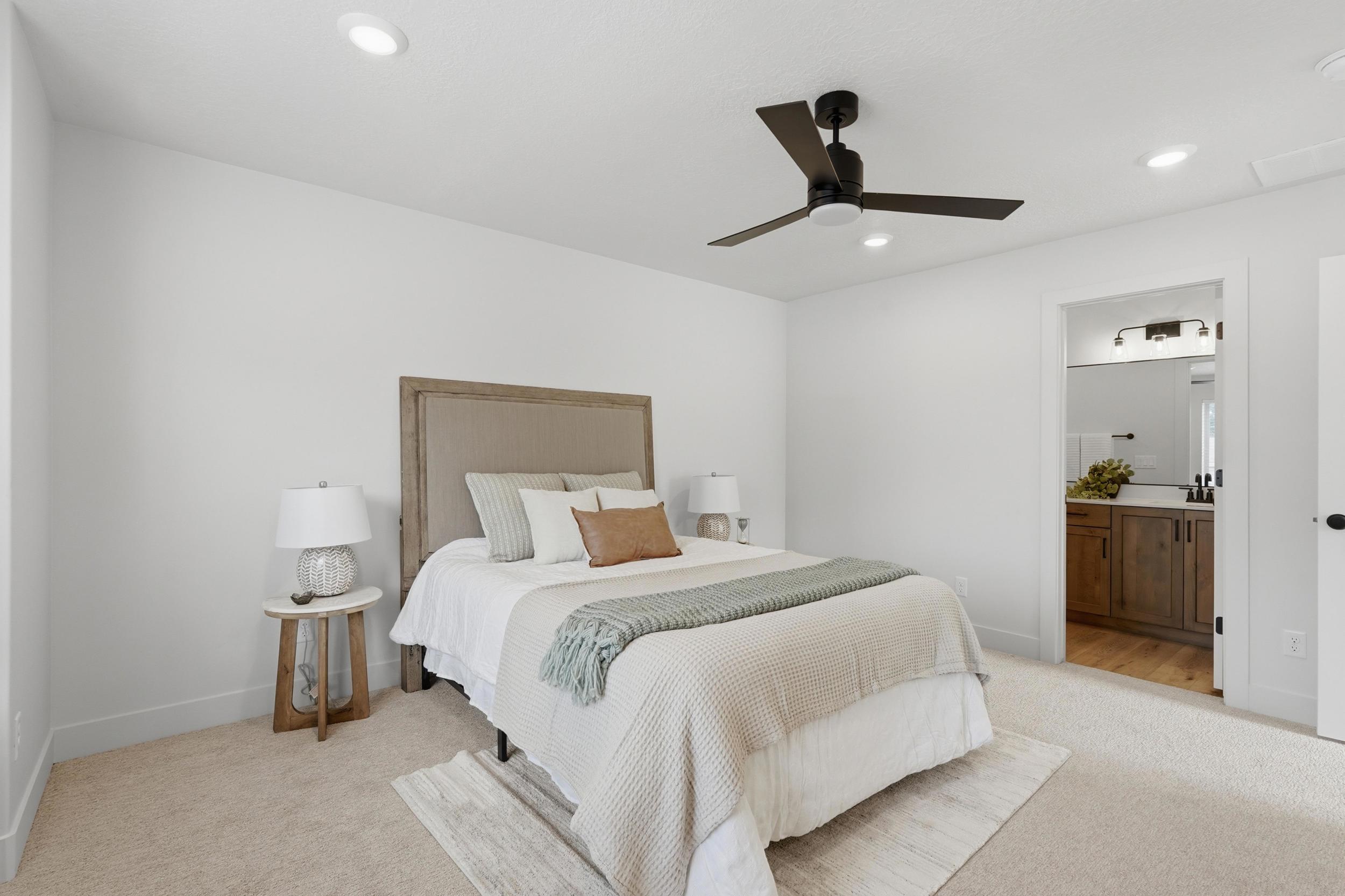 Bedroom with neutral carpet flooring and white walls