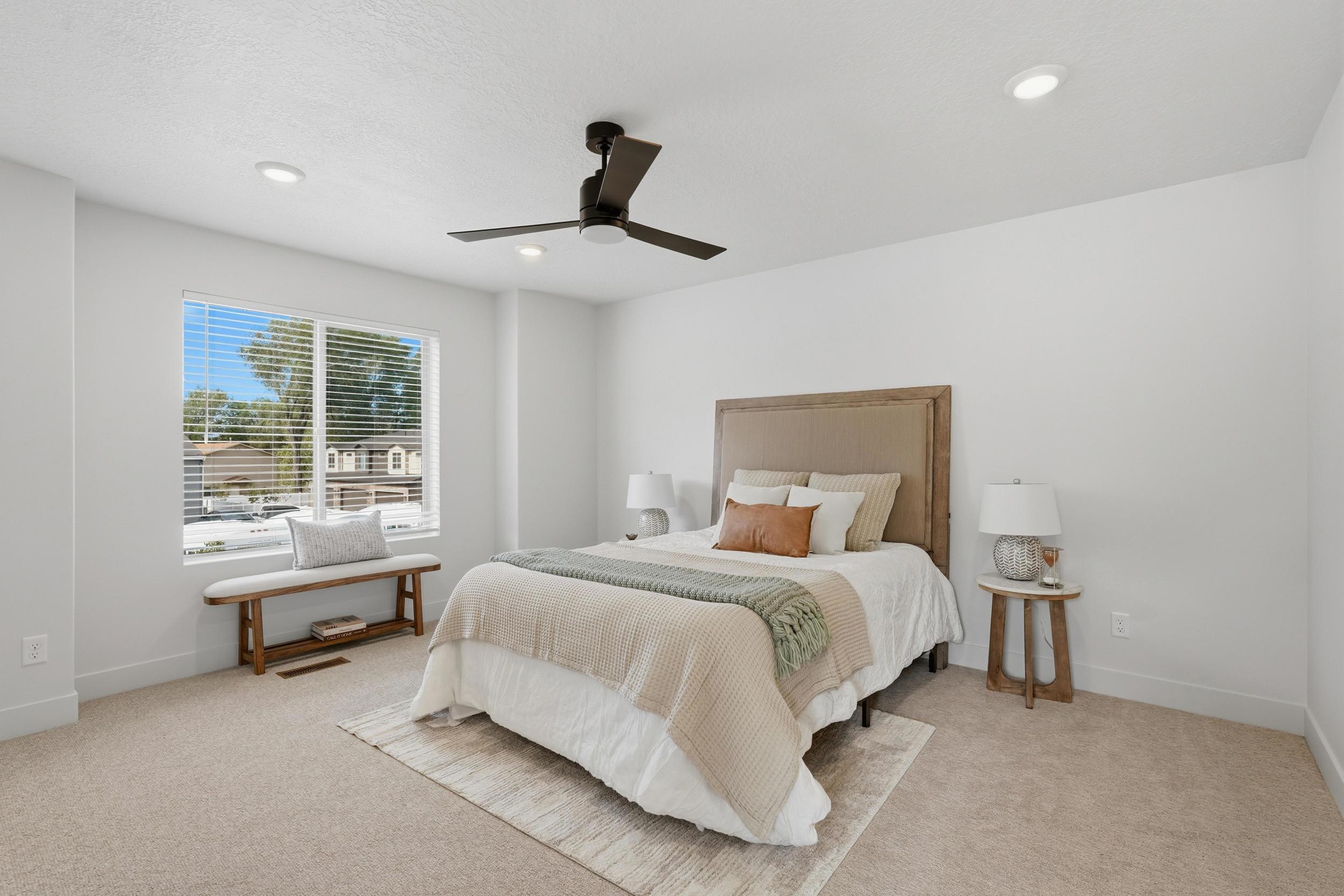 Bedroom featuring plush carpeting, a large window with blinds, recessed lighting, and a ceiling fan