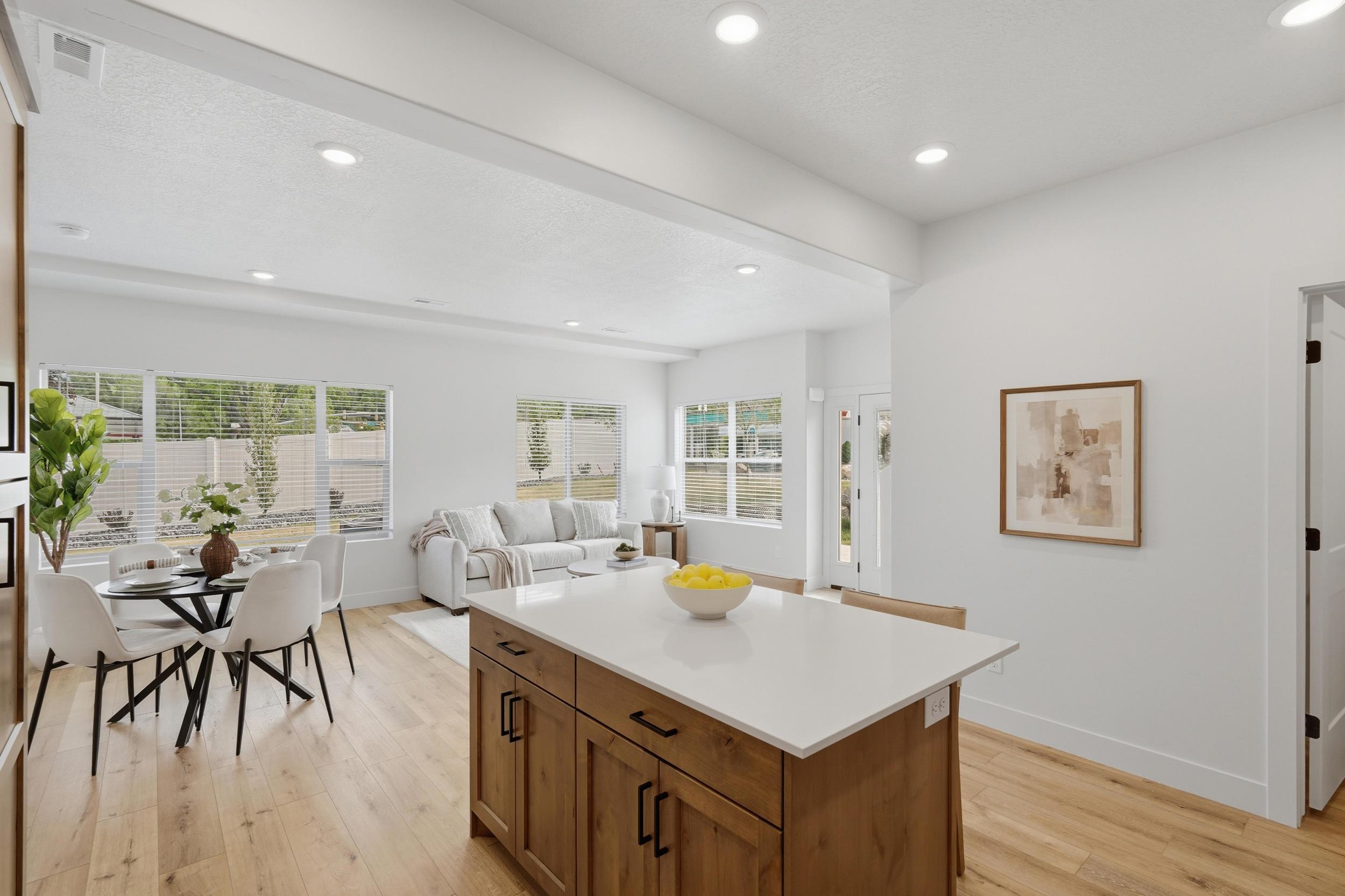 Central kitchen island with wood-finish cabinetry and a light-toned countertop