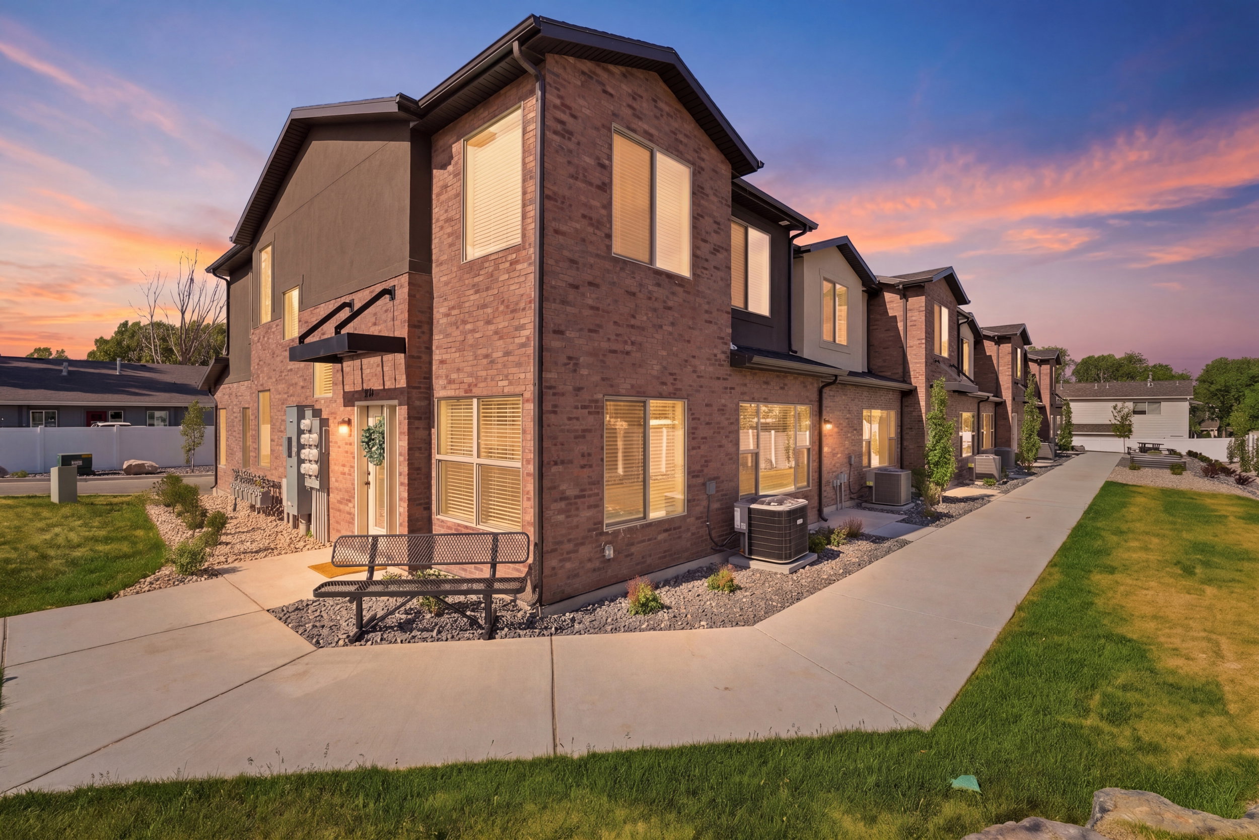Modern townhome exterior featuring brick and stucco siding