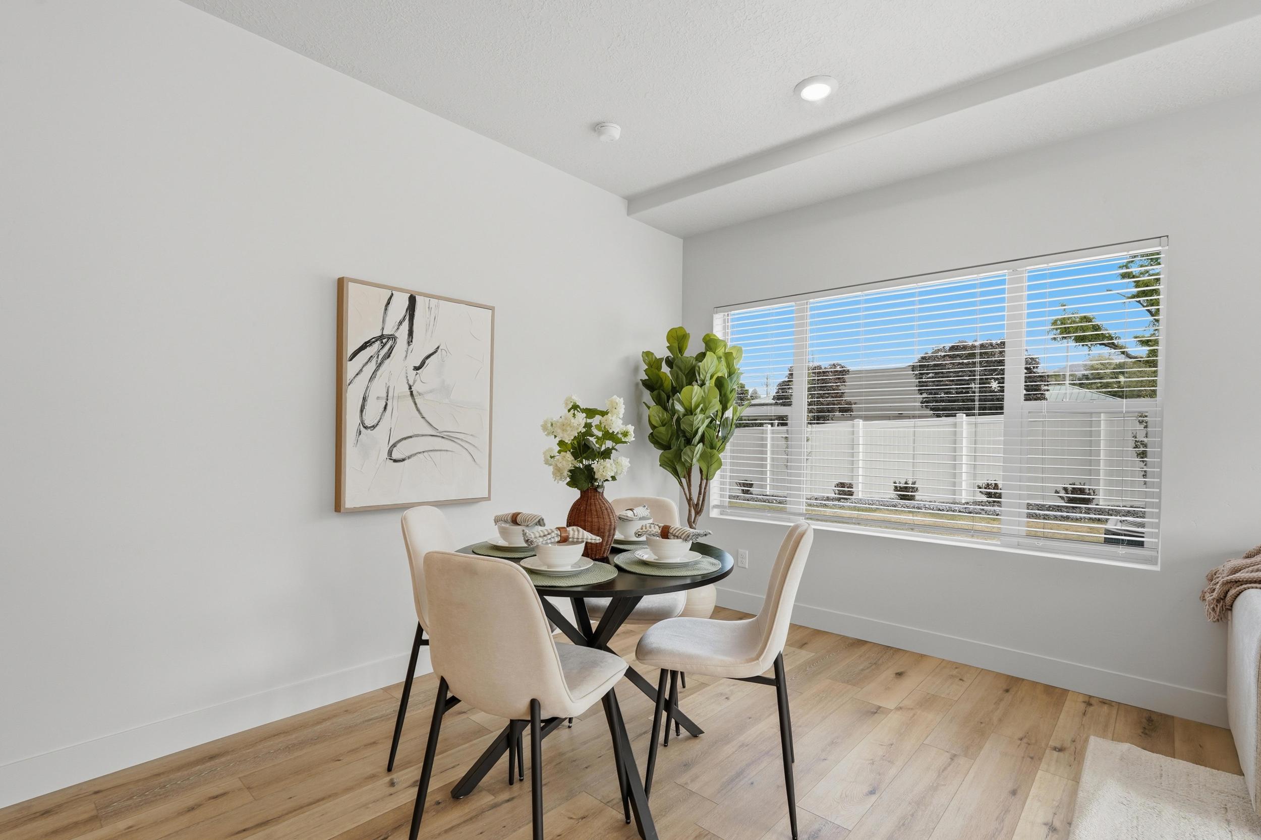 Dining area featuring wood-finish flooring, recessed lighting, and a large window with horizontal blinds