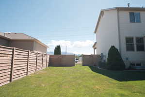 Expansive fenced yard with a manicured lawn