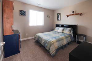 Neutral-toned walls complement the carpeted flooring