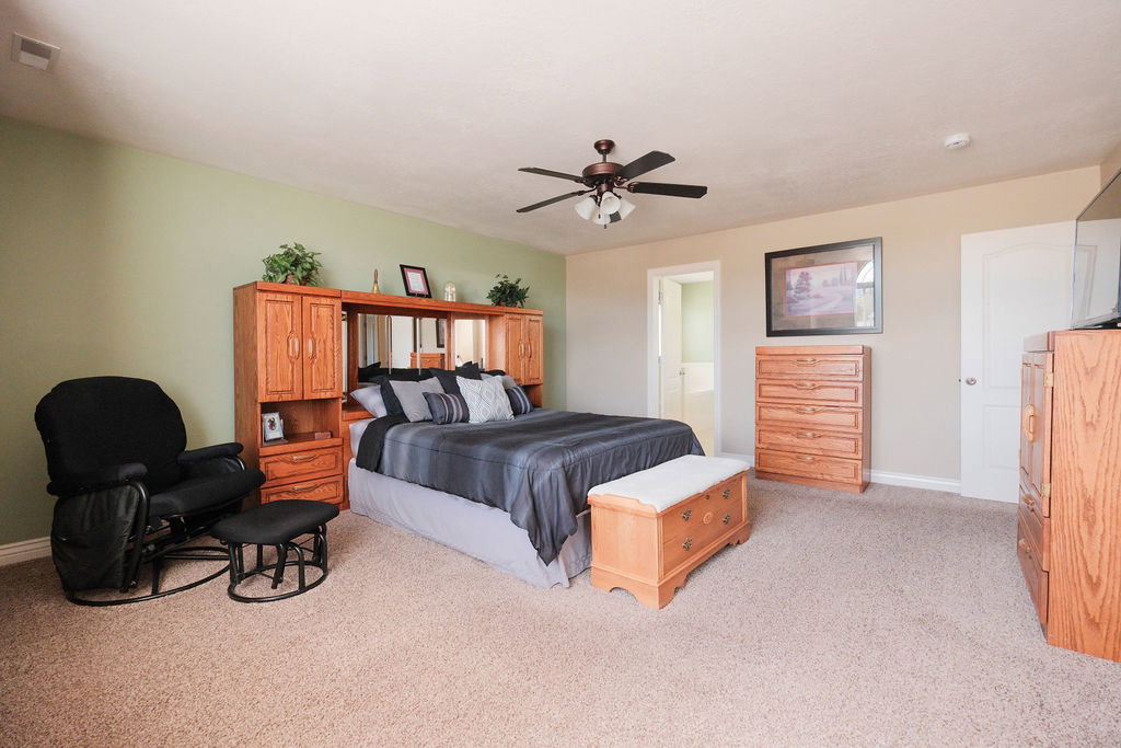 Spacious room featuring carpeting, a ceiling fan with integrated lighting, and a two-tone wall finish