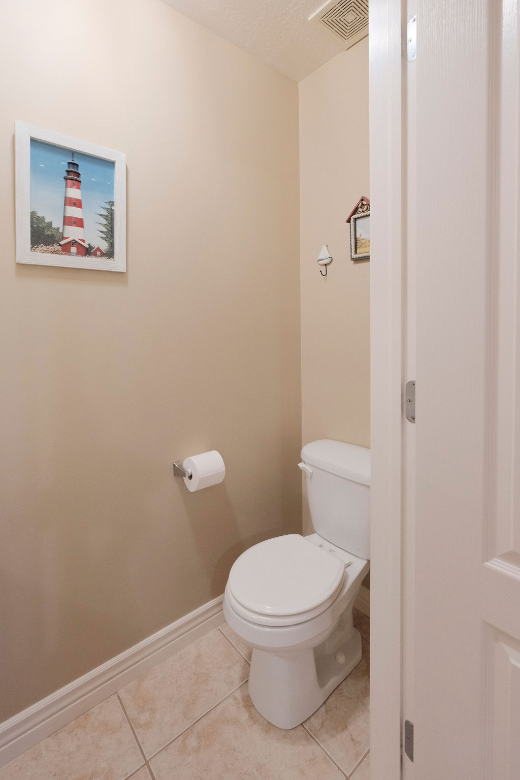White toilet fixture with chrome toilet paper holder