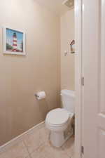 White toilet fixture with chrome toilet paper holder