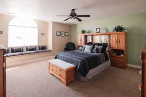 Spacious room featuring a large arched window with an integrated window seat