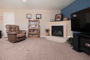 Corner fireplace featuring a tile surround and hearth