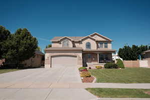Two-story stucco and brick-front residence with a front-facing attached two-car garage