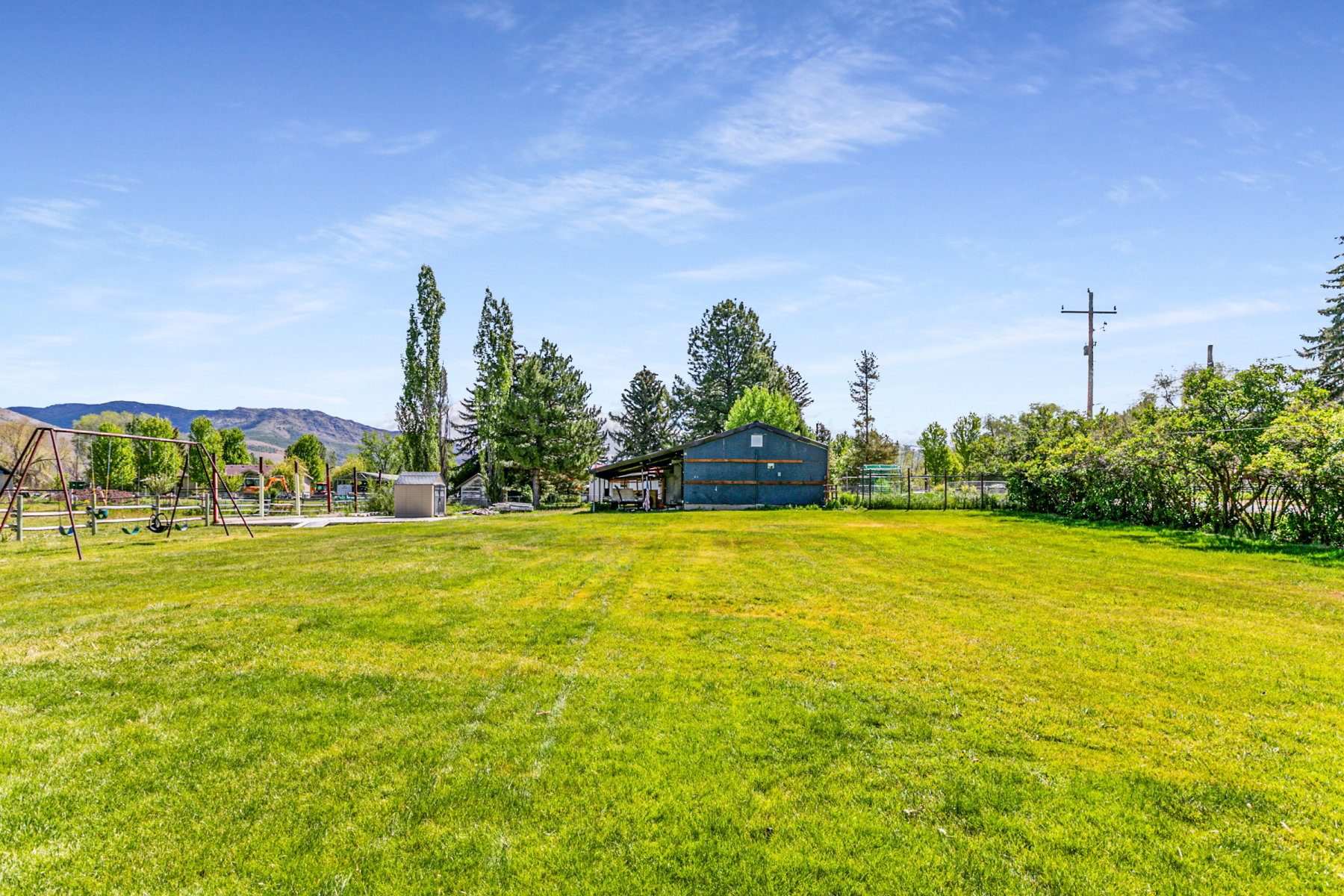 Expansive green lawn with mountain backdrop