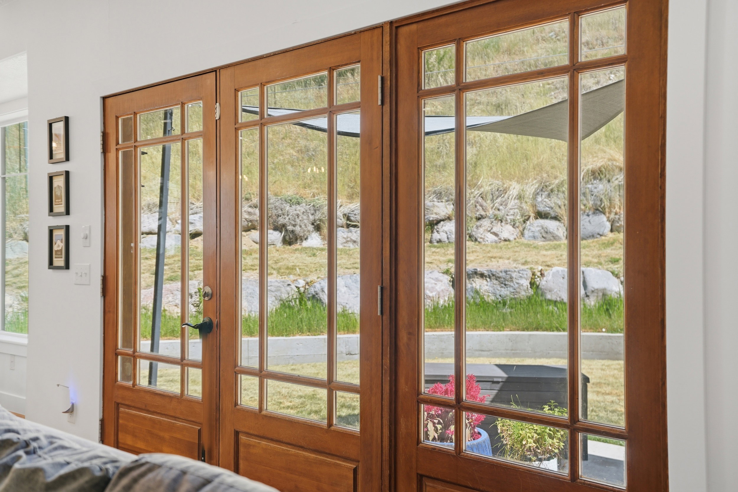 Warm French doors with multiple window panes is the frame to your nature viewing...and yes, you may be seeing deer in your backyard