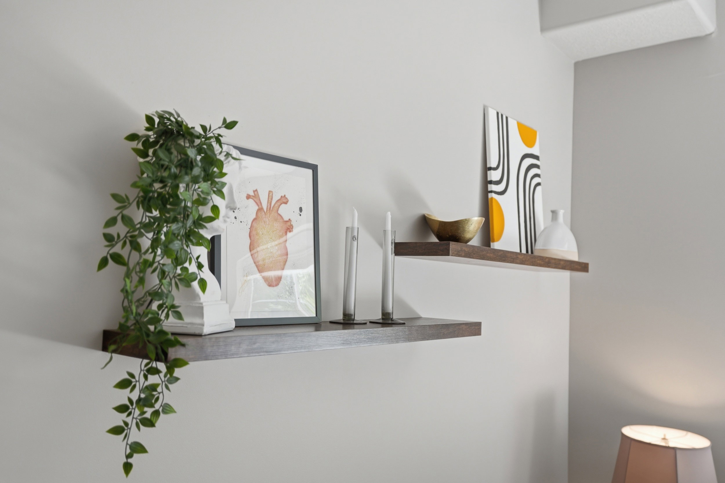 Floating shelves constructed from dark wood-finish material