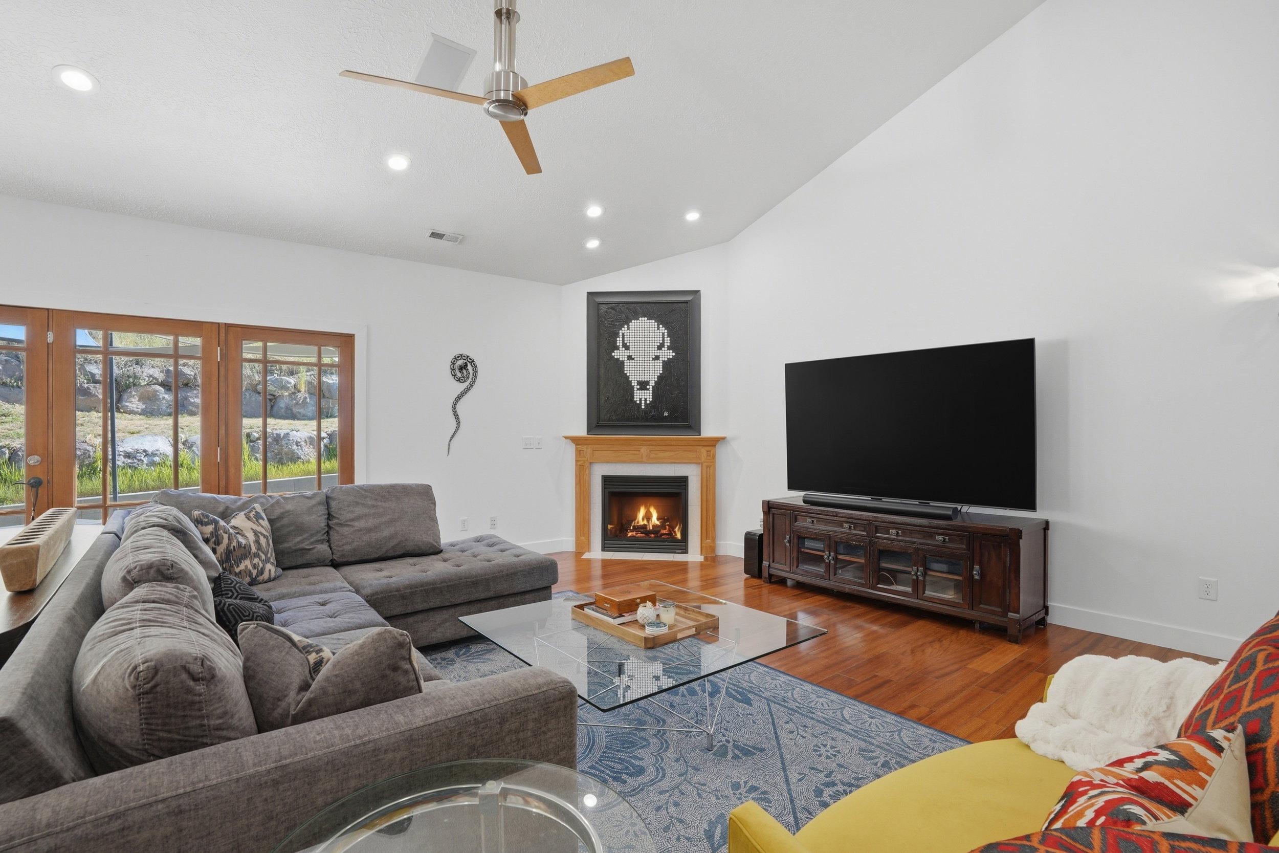 The gas fireplace creates a warm ambiance in this big & comfortable living room