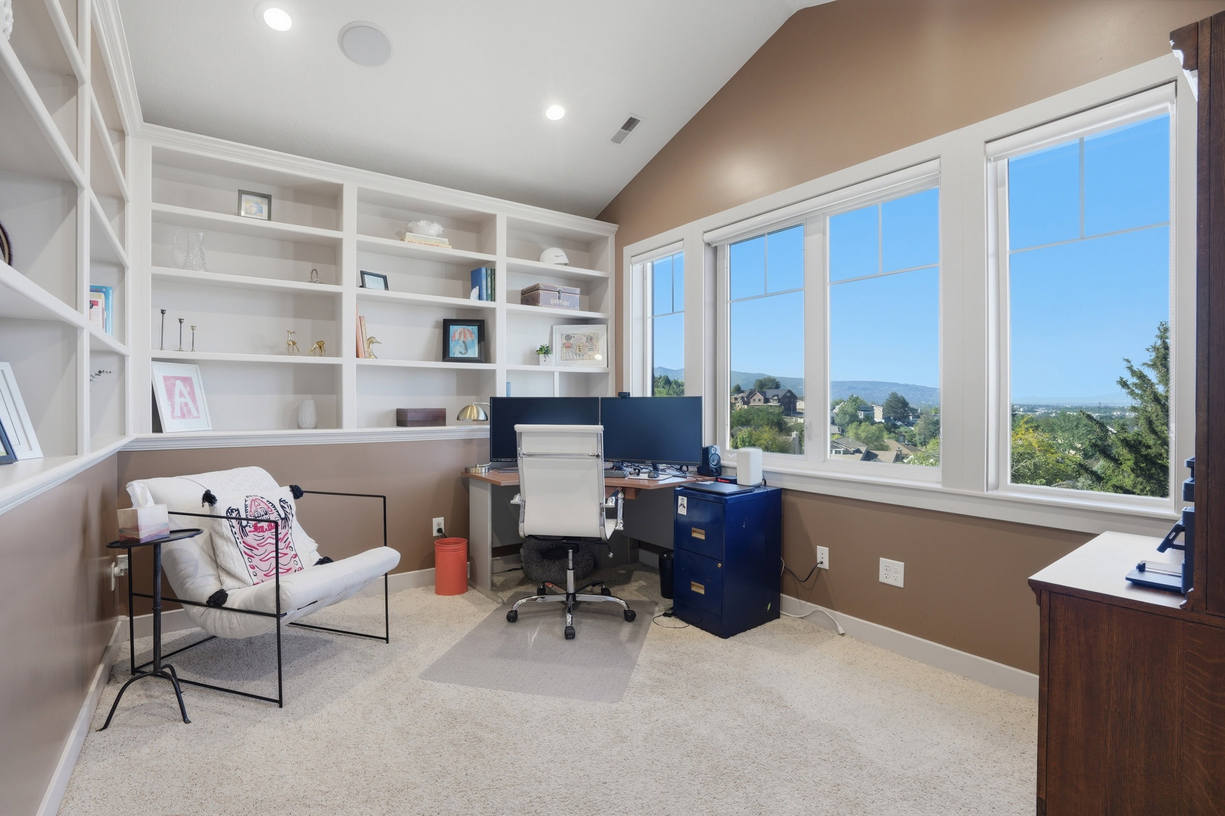 Expansive windows looking south, complemented by a vaulted ceiling and recessed lighting.