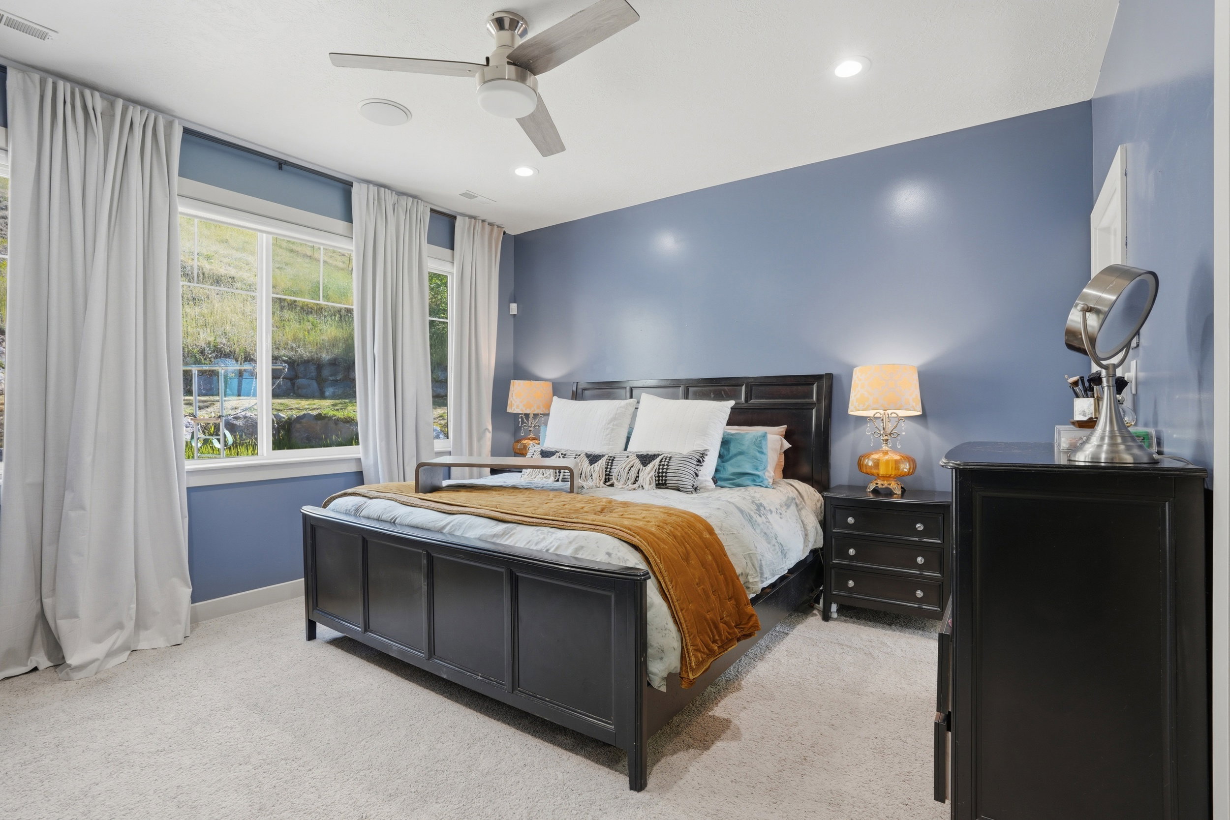 Primary bedroom is a beautiful sanctuary with big windows and plenty of space