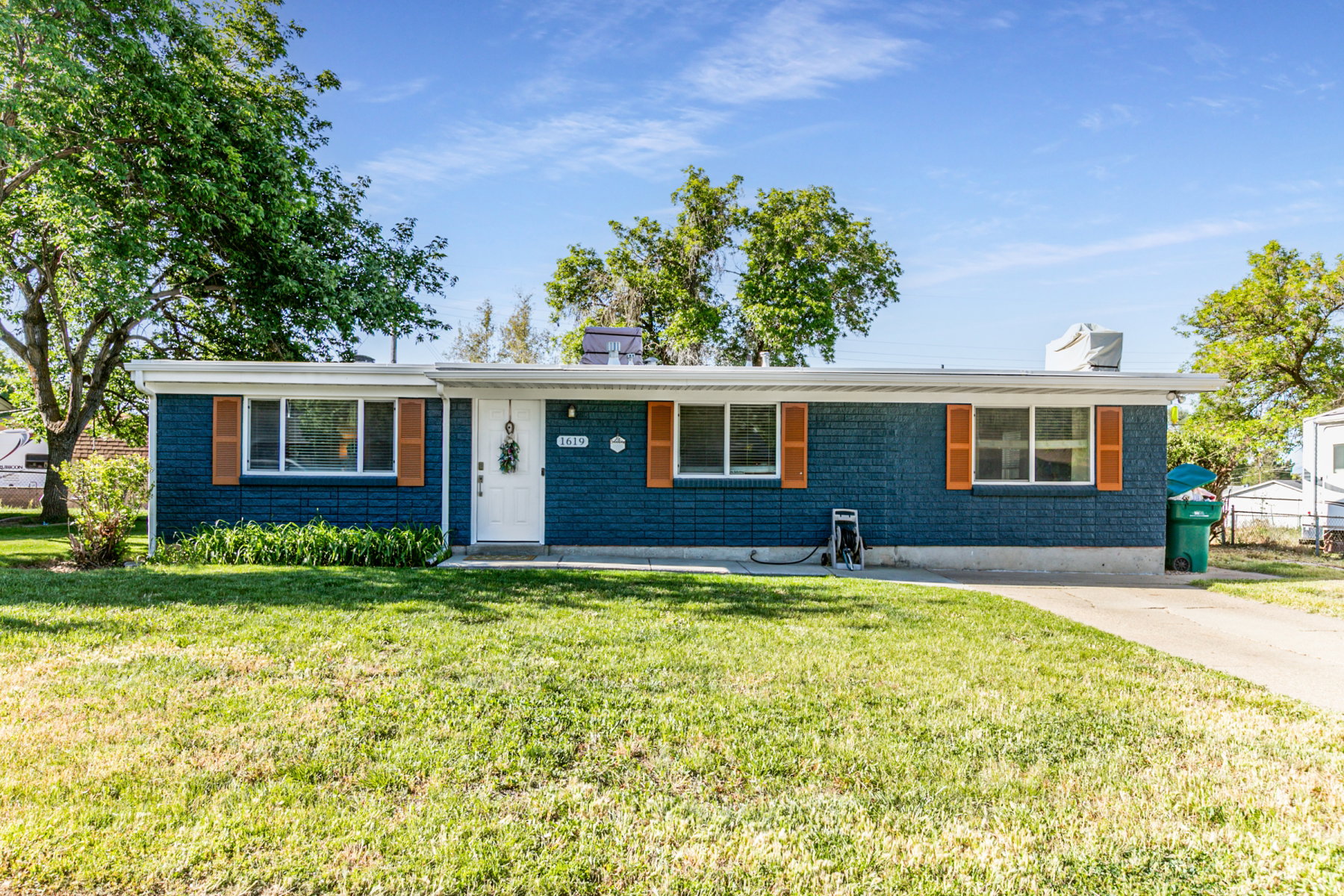 Single-story residence featuring a blue brick exterior and white trim