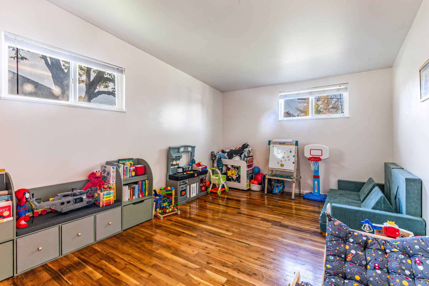 Hardwood flooring throughout a spacious room with light-colored walls