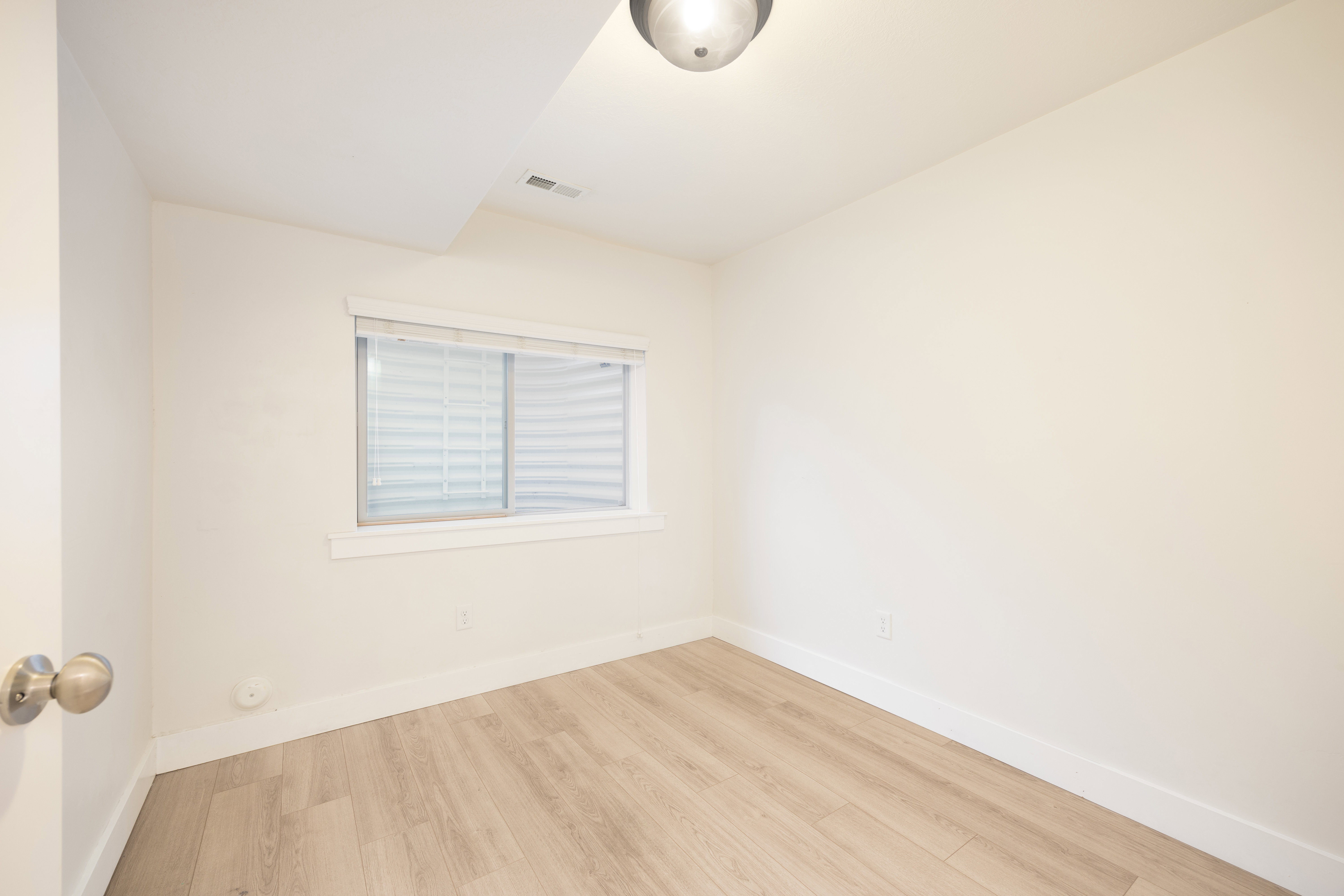 Light wood-finish flooring complements the neutral wall tones