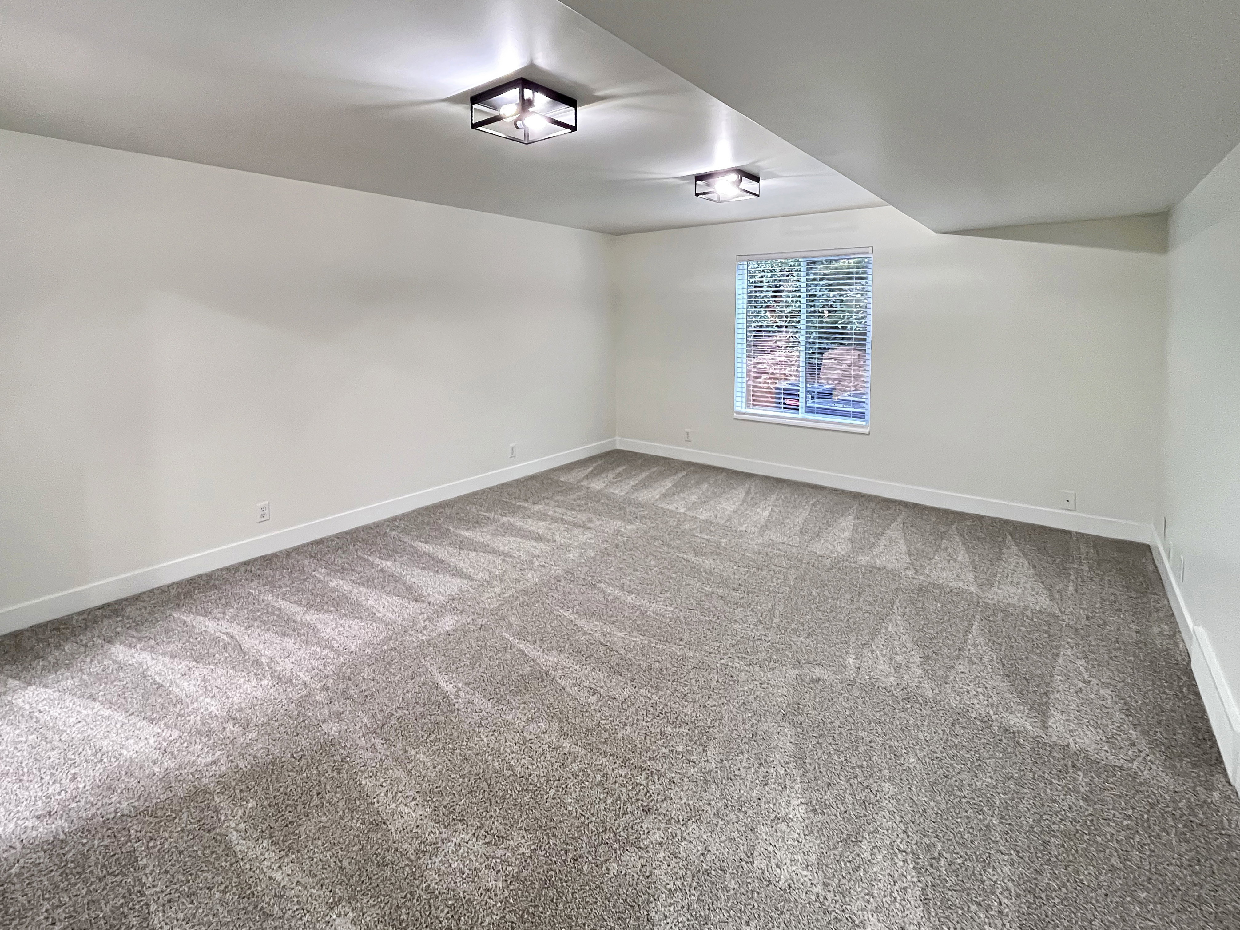 VIRTUALLY STAGED-Primary Bedroom featuring tall baseboards, cozy plush carpet, warm tones, and convenient bathroom