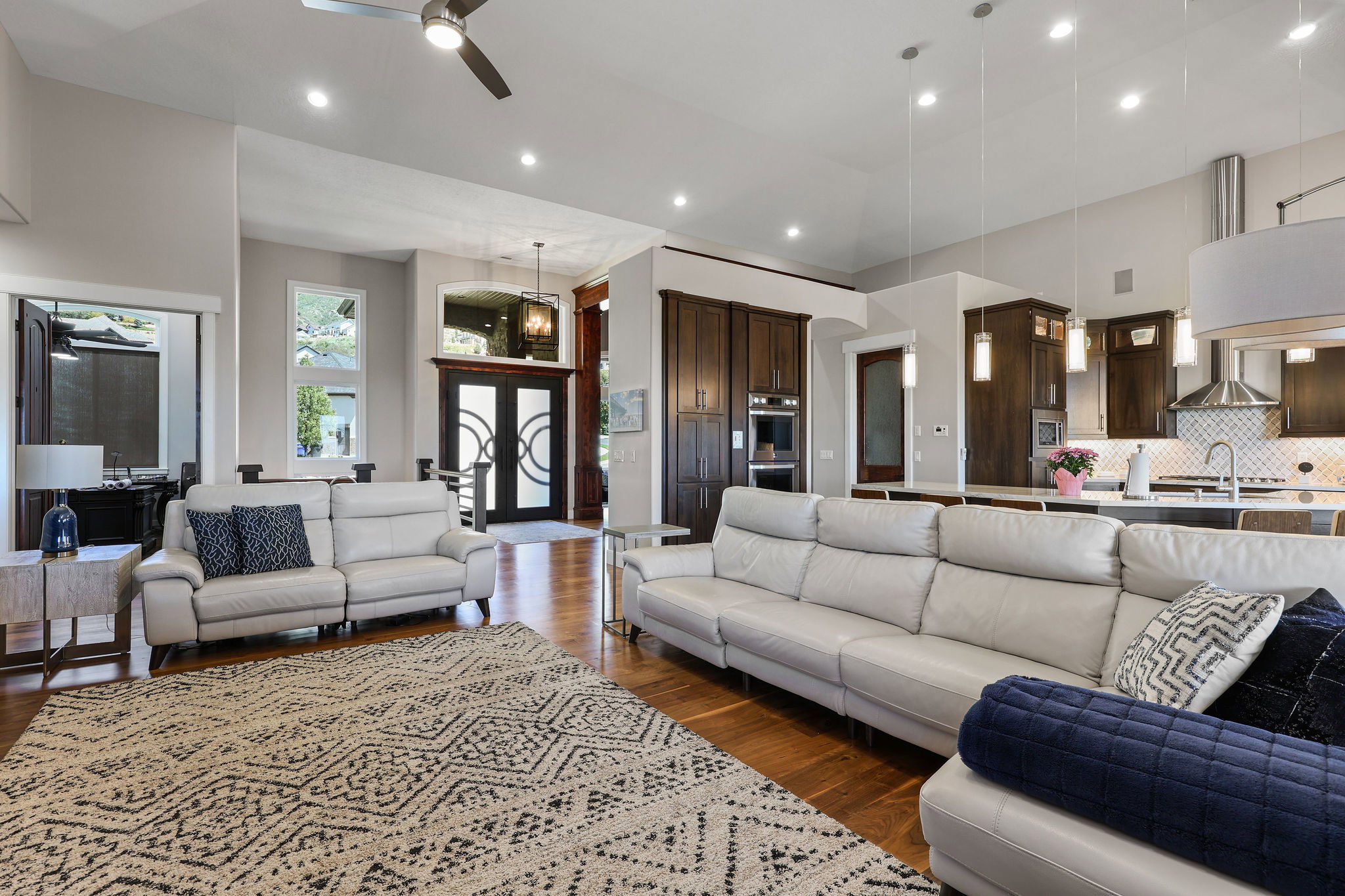 Open-concept living space featuring wood-finish flooring, recessed lighting, and a ceiling fan